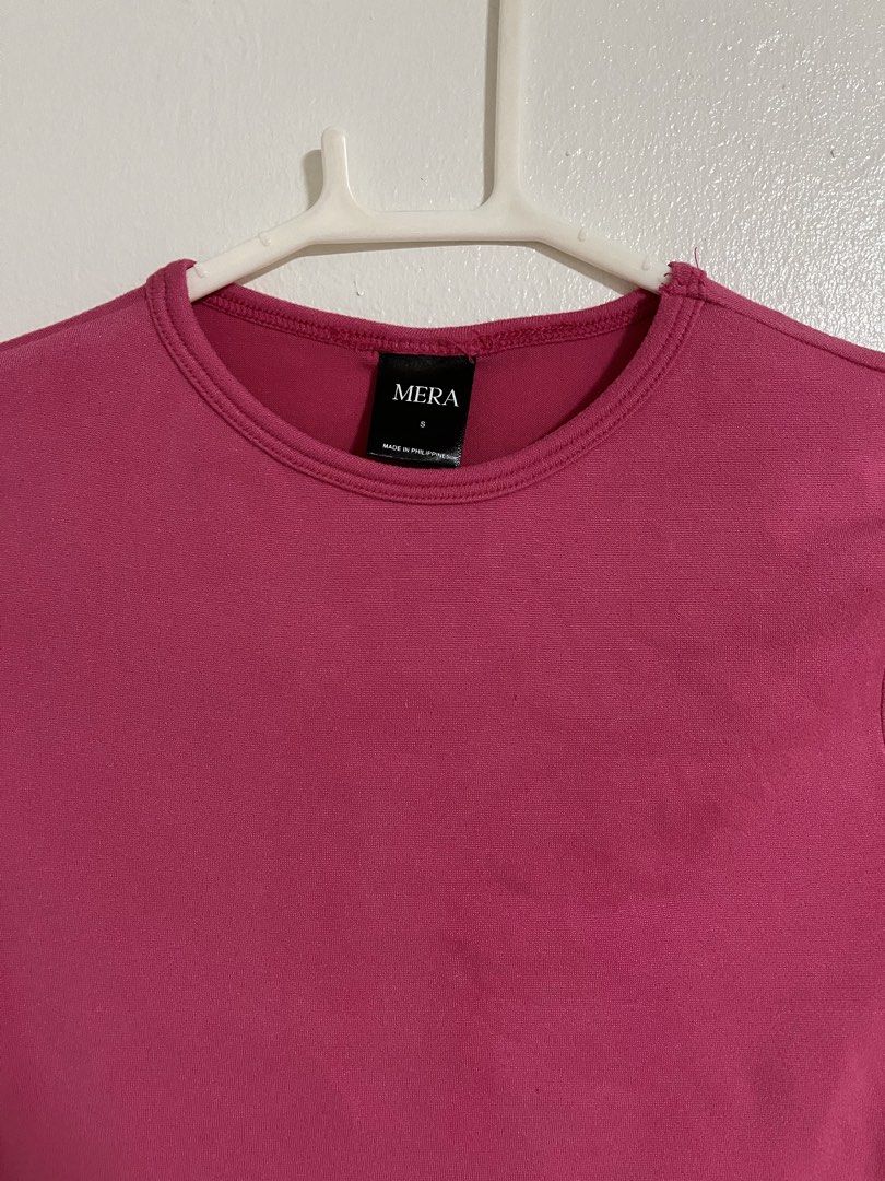 MERA Pink Crop Top (Category: Shirts) located in Cabuyao City. Submitted by rdtrmt (Listing ID 1470743288, Image 2). Description: - Brand: MERA - Size: Small (tag at inner collar) - Color: Bright pink / solid - Style: Short sleeves, crew neckline, plain back crop top - Pairing tip: Easy to match with high-waisted jeans or skirts - Condition: still in good condition.