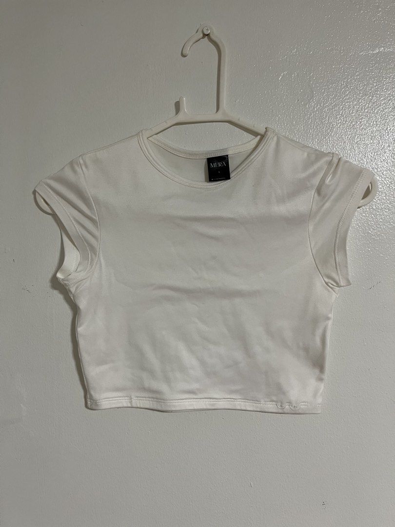 Mera White Crop Top Size S (Category: Shirts) located in Cabuyao City. Submitted by rdtrmt (Listing ID 1470743236, Image 1). Description: - Brand: Mera - Size: Small - Color: White - Style: Crop top with round neckline and plain back - Details: Short cap sleeves with structured shoulders - Fabric: Clean and smooth texture - Condition: still in good condition.
