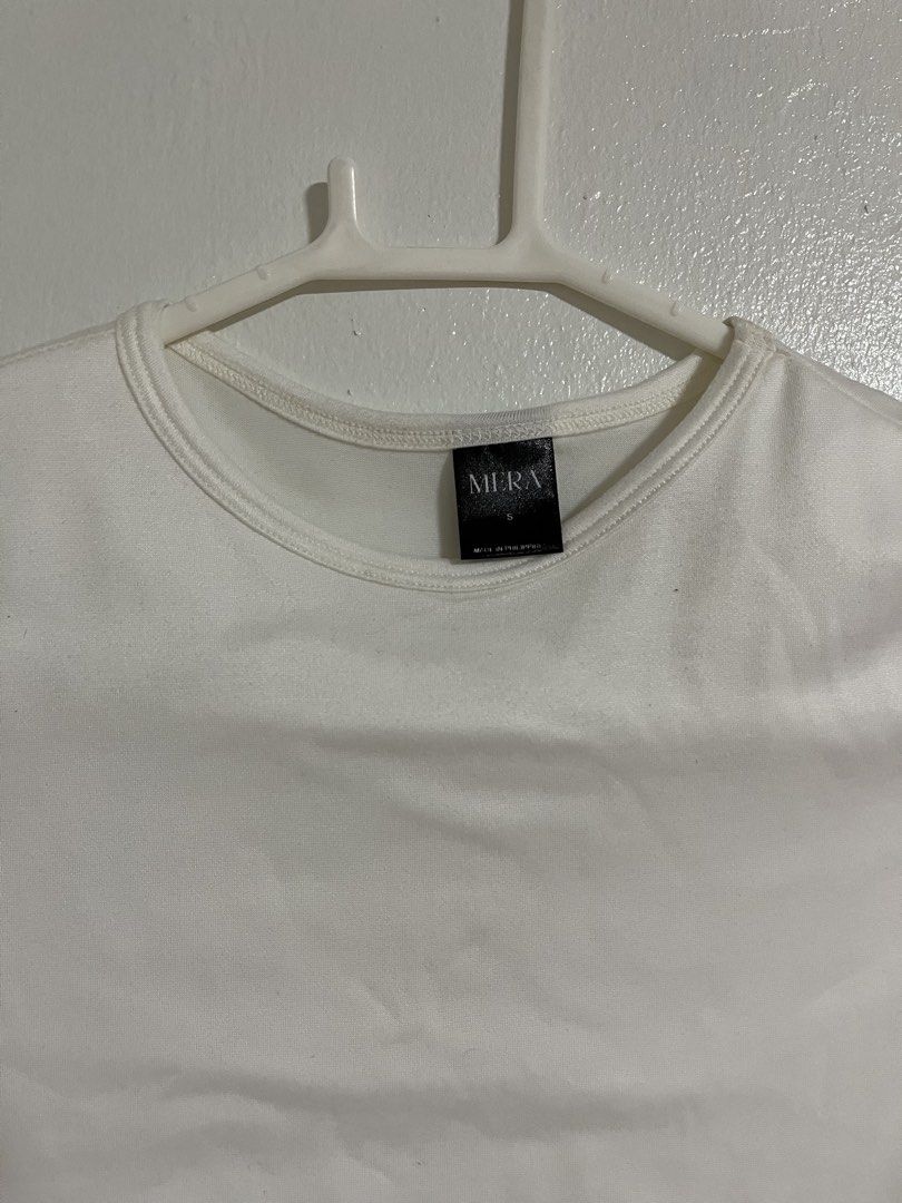 Mera White Crop Top Size S (Category: Shirts) located in Cabuyao City. Submitted by rdtrmt (Listing ID 1470743236, Image 2). Description: - Brand: Mera - Size: Small - Color: White - Style: Crop top with round neckline and plain back - Details: Short cap sleeves with structured shoulders - Fabric: Clean and smooth texture - Condition: still in good condition.