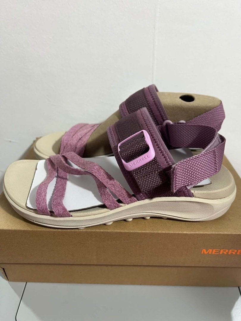 Merrell Purple Outdoor Sandals (Category: Sandals) located in Baguio. Submitted by heath2600 (Listing ID 1470590006, Image 1). Description: - Brand: Merrell - Color: Purple with pink buckle branding and neutral toned footbed/sole - Design: Multi-strap forefoot with adjustable ankle strap - Condition: Excellent, comes with original shoebox and cardboard inserts to maintain shape - Ideal for: Casual wear, outdoor activities, and daily comfort - RFS