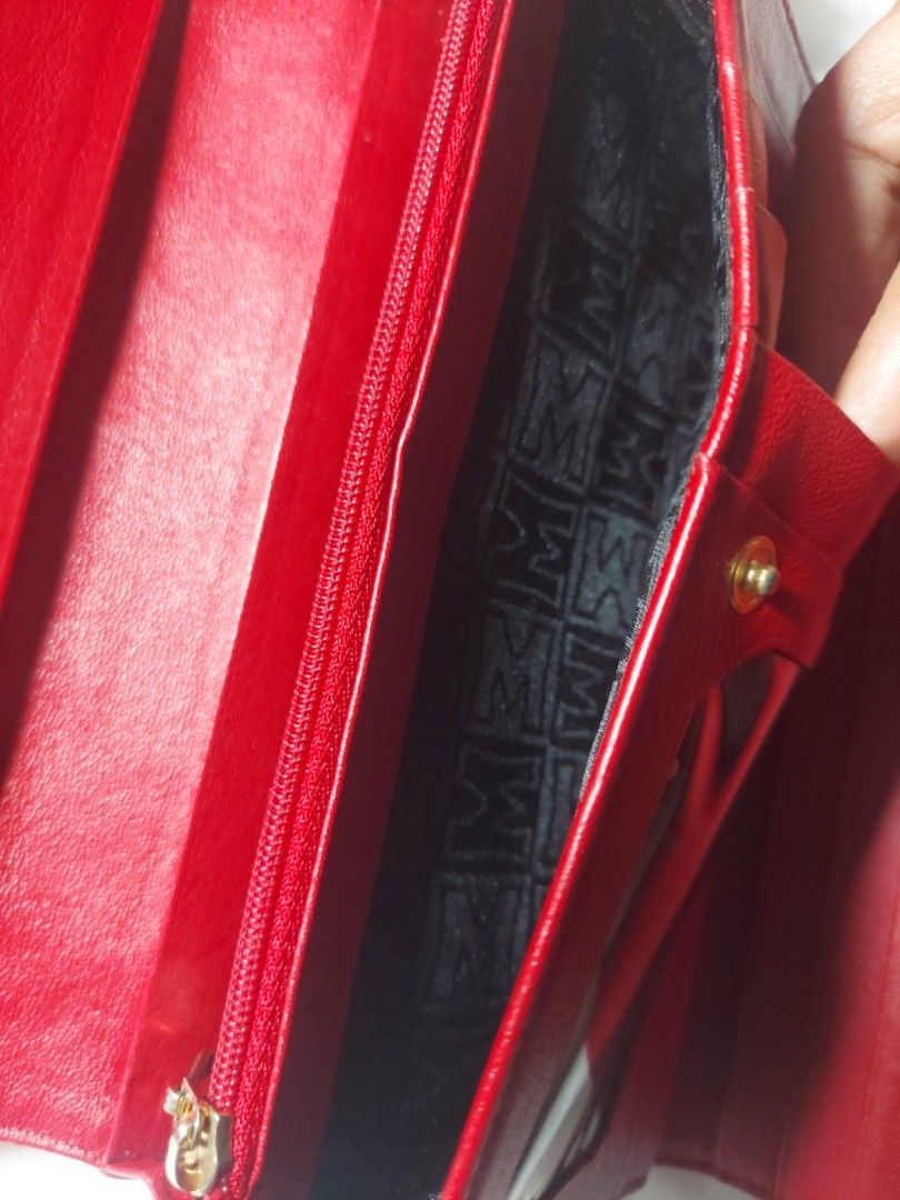 Metrocity Red Leather Long Wallet (Category: Wallets & Card holders) located in Quezon City. Submitted by never_a_clutter (Listing ID 1470591419, Image 3). Description: - Brand: Metrocity - Color: Bright red with gold hardware details - Material: Genuine leather - Closure: Secure snap button - Interior: Multiple card slots, ID window, long slip compartments, and zippered coin pocket - Lining: Signature Metrocity monogram pattern - Condition: 9/10