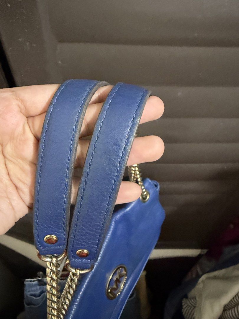 Michael Kors Blue Leather Shoulder Bag (Category: Shoulder Bags) located in Rizal. Submitted by lovegclothingph (Listing ID 1470673580, Image 3). Description: - Brand: Michael Kors - Material: Genuine leather in a bright blue shade - Hardware: Gold-tone with signature MK circular logo - Straps: Combination of chain and leather - Closure: Front flap - Compartments: Exterior back slip pocket - Condition: Good, with minor scuffs on the metal logo an