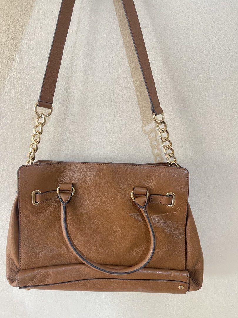 Michael Kors Brown Leather Shoulder Bag Tote (Category: Luxury Bags & Wallets) located in Quezon City. Submitted by mvaldez (Listing ID 1470587395, Image 2). Description: - Brand: Michael Kors - Material: Premium brown leather with gold-tone hardware - Straps: Dual top handles and stylish chain shoulder strap - Interior: Signature Michael Kors monogram fabric lining - Compartments: Center zip divider, plus convenient slip and zip side pockets - C