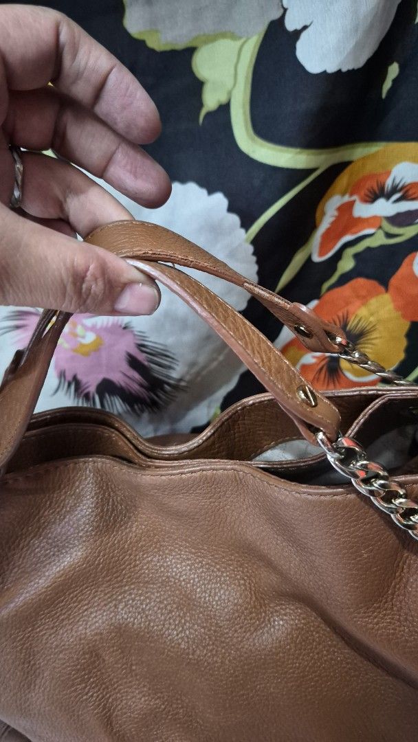 Michael Kors Brown Leather Shoulder Bag (Category: Looking For) located in Baguio. Submitted by jhaz_bags (Listing ID 1470679785, Image 3). Description: - Brand: Michael Kors - Material: Brown pebbled leather with gold-tone hardware - Straps: Dual options with chain and leather handles - Accessories: Iconic MK logo charm included - Interior: Fabric lining with convenient inside pockets - Authenticity: Features 'Made in Vietnam' tag - Condition: S