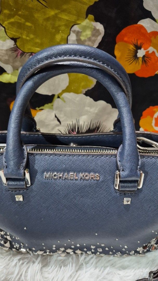Michael Kors Navy Blue Studded Satchel Bag (Category: Everything Else Others) located in Baguio. Submitted by jhaz_bags (Listing ID 1470675821, Image 1). Description: - Brand: Michael Kors - Color: Navy Blue - Material: Genuine Leather with Silver Stud Details - Hardware: Polished Silver - Straps: Double top handles + adjustable/removable shoulder strap - Closure: Secure zippered main closure - Interior: Signature MK logo fabric lining with handy
