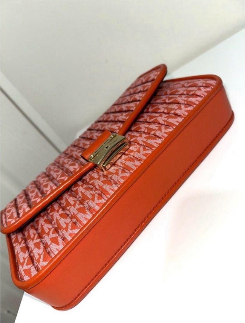 Michael Kors Orange Monogram Pleated Shoulder Bag (Category: Shoulder Bags) located in Bulacan. Submitted by sunflower1789 (Listing ID 1470707770, Image 3). Description: READ DESCRIPTION! - original (not class a or high quality) - bought in malaysia (michael kors store) - with extra long strap as cross body bag - small cracks in the bag (unnoticeable) - still in very good condition - can send more pics just dm - slightly negotiable - J&T / lalamo