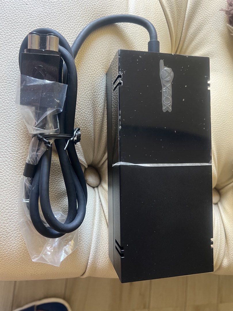 Microsoft Xbox One Original Power Supply Brick (Category: Cables & Chargers) located in Paranaque City. Submitted by bartheramil (Listing ID 1470624475, Image 1). Description: - 100% Original Microsoft Xbox One power supply unit - Standard replacement black brick design - Includes attached cable and plug connector - Stored cleanly with plastic wrap on the connector - Model details verified on the base label. This is a 110V item in almost brand-ne