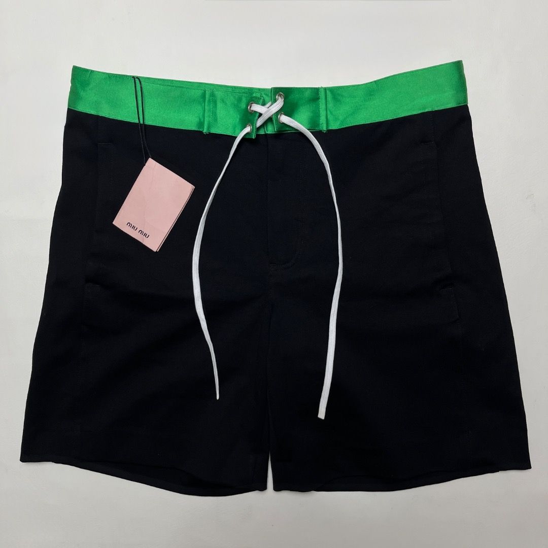 Miu Miu Laced Shorts (Category: Shorts) located in Caloocan City. Submitted by achilles_grails (Listing ID 1470671727, Image 2). Description: - Brand: Miu Miu - Item: Laced Shorts - Color: Black body with vibrant green waistband and white lace-up detail - Size: 38 - Condition: Brand new with tags attached - Features: Back pocket with button closure, high-end designer finish.