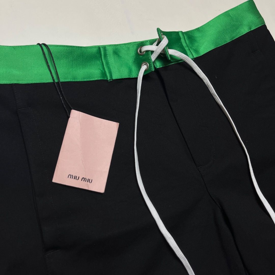 Miu Miu Laced Shorts (Category: Shorts) located in Caloocan City. Submitted by achilles_grails (Listing ID 1470671727, Image 3). Description: - Brand: Miu Miu - Item: Laced Shorts - Color: Black body with vibrant green waistband and white lace-up detail - Size: 38 - Condition: Brand new with tags attached - Features: Back pocket with button closure, high-end designer finish.
