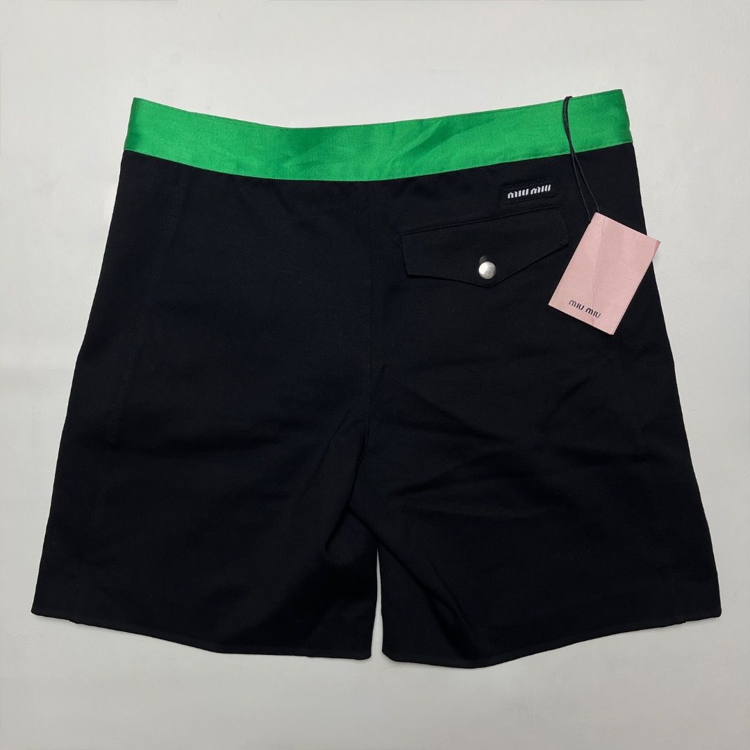 Miu Miu Laced Shorts (Category: Shorts) located in Caloocan City. Submitted by achilles_grails (Listing ID 1470671727, Image 1). Description: - Brand: Miu Miu - Item: Laced Shorts - Color: Black body with vibrant green waistband and white lace-up detail - Size: 38 - Condition: Brand new with tags attached - Features: Back pocket with button closure, high-end designer finish.