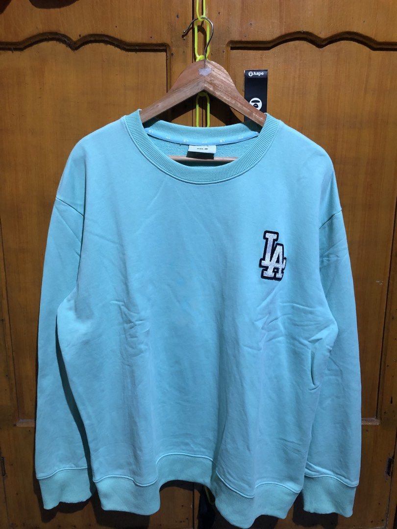 MLB Los Angeles Dodgers Mint Green Sweatshirt (Category: Coats, Jackets and Outerwear) located in Manila. Submitted by streetwear_only (Listing ID 1470727640, Image 2). Description: - Authentic MLB Los Angeles Dodgers sweatshirt - Color: Mint green - Size: Small - Small embroidered LA logo on the chest - Large LA logo patch graphic printed on the back - Classic crew neck style with ribbed cuffs and hem - Inner collar tape branding - Original bran