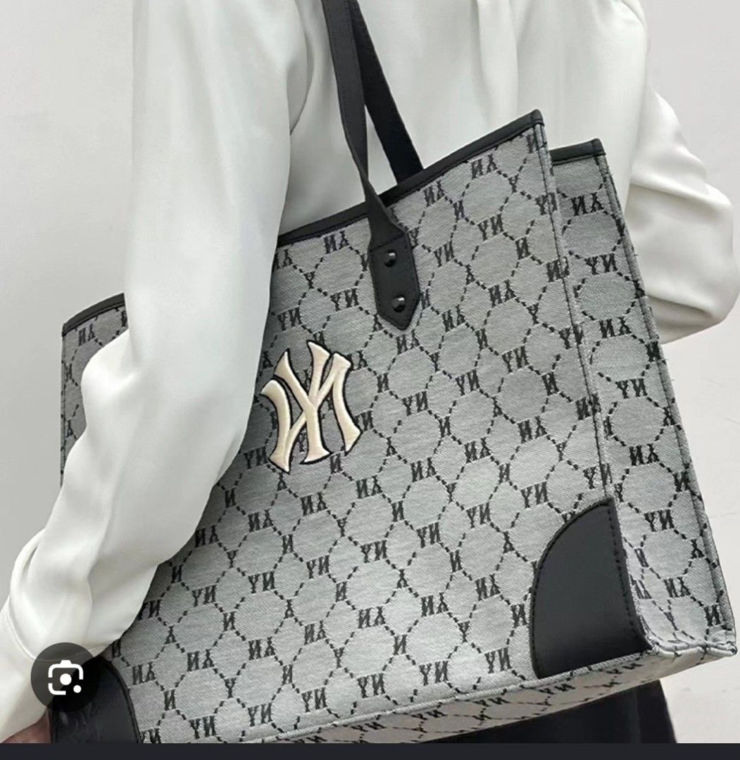 MLB Monogram NY Yankees Tote Bag with Pouch (Category: Tote Bags) located in Manila. Submitted by lene48 (Listing ID 1470636649, Image 1). Description: MLB tote bag in grey and black monogram print. Raised NY Yankees logo right on the front. Double black shoulder straps, leather-style bottom corner patches. Roomy interior with a matching zippered pouch included. Clean lining, inner zip pocket, and inner brand tag. Great daily carryall for school,