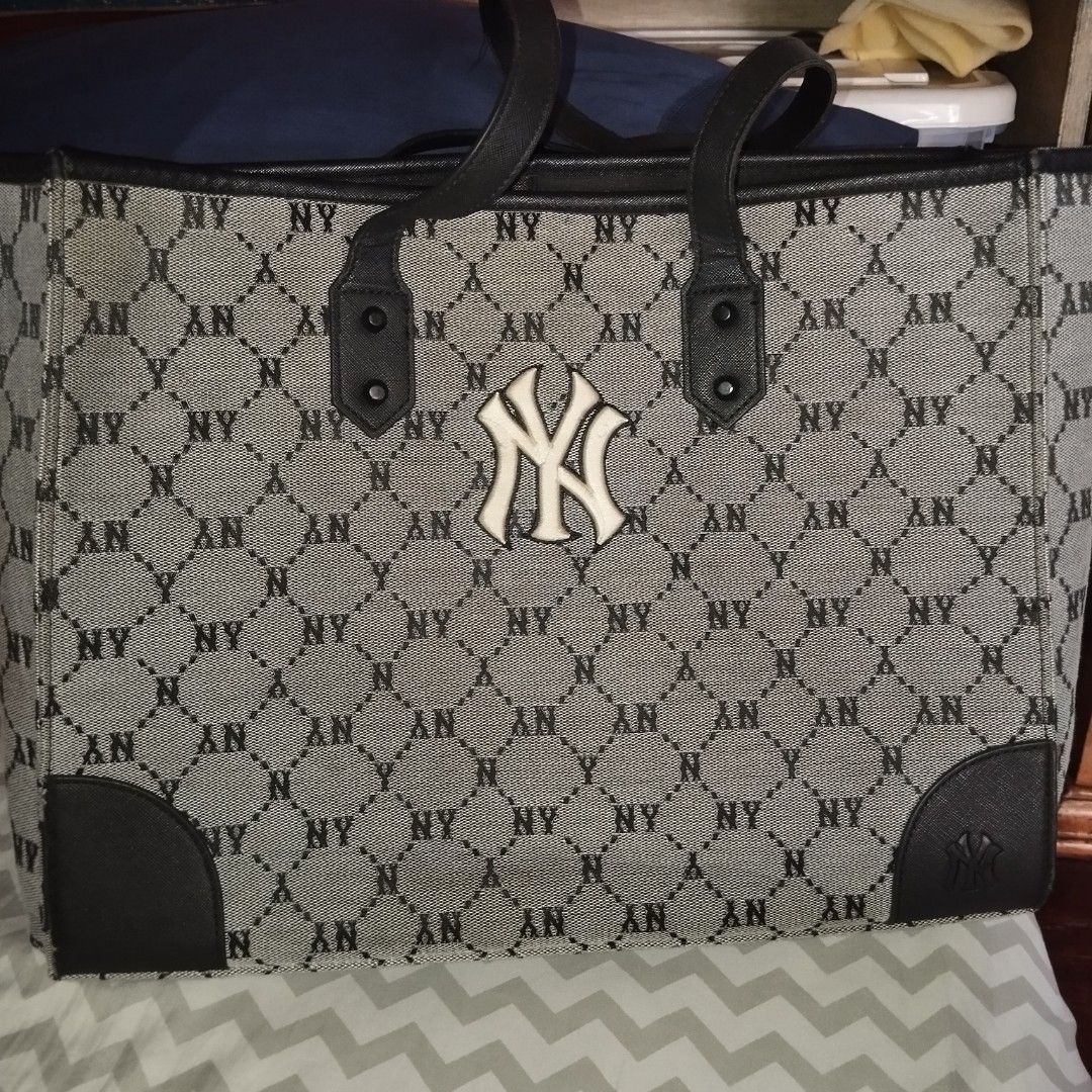 MLB Monogram NY Yankees Tote Bag with Pouch (Category: Tote Bags) located in Manila. Submitted by lene48 (Listing ID 1470636649, Image 3). Description: MLB tote bag in grey and black monogram print. Raised NY Yankees logo right on the front. Double black shoulder straps, leather-style bottom corner patches. Roomy interior with a matching zippered pouch included. Clean lining, inner zip pocket, and inner brand tag. Great daily carryall for school,