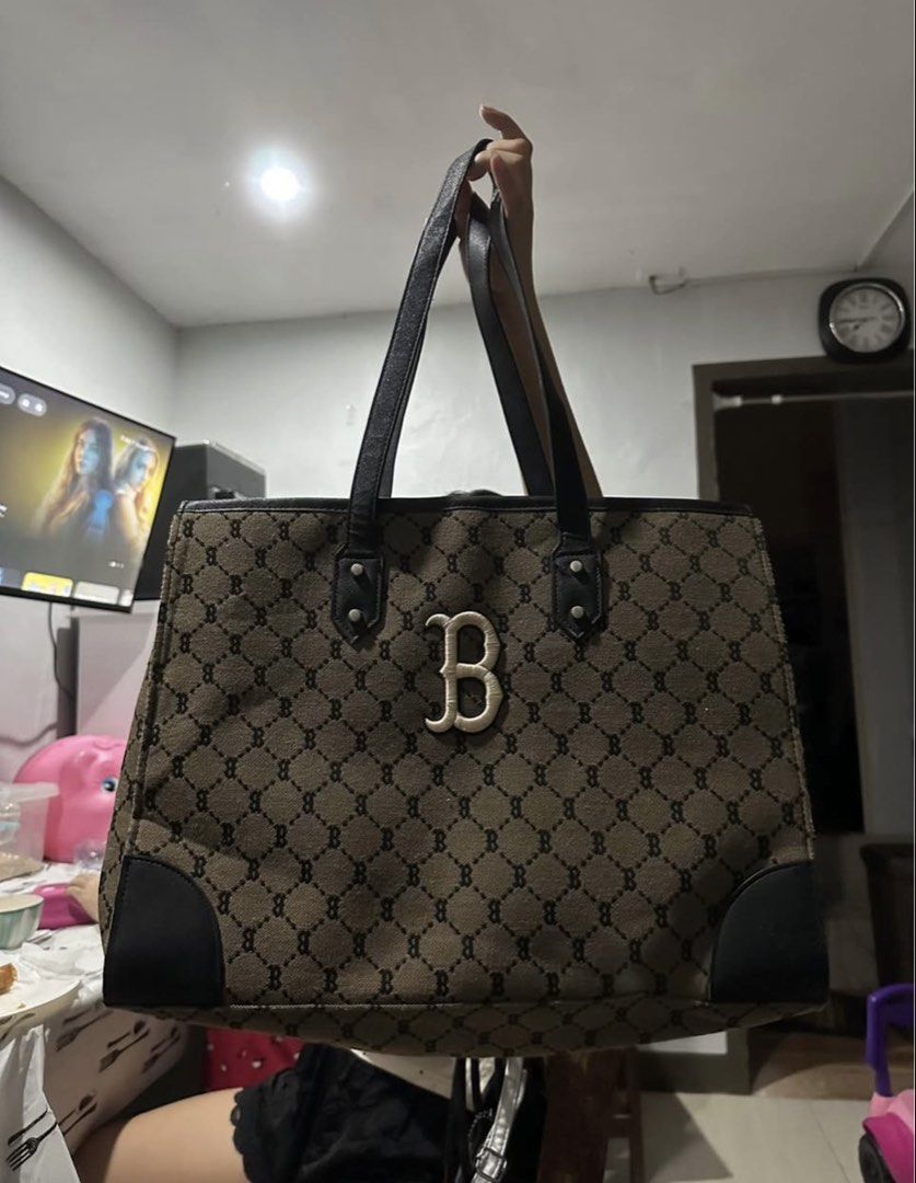 MLB Monogram Tote Bag Brown Black (Category: Tote Bags) located in Manila. Submitted by zayzay08 (Listing ID 1470728404, Image 1). Description: - Brand: MLB - Design: Brown and black monogram pattern with a large white 'B' letter applique - Straps & Hardware: Dual black shoulder straps with silver hardware studs - Interior: Spacious main compartment, zip pocket with MLB logo zipper pull, and brand label.