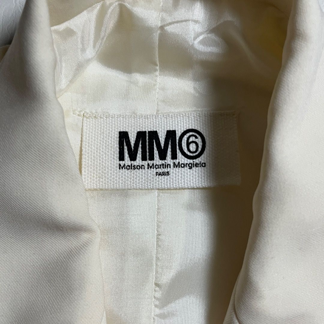 MM6 Maison Martin Margiela Circular Blazer Jacket (Category: Sleeveless) located in Caloocan City. Submitted by achilles_grails (Listing ID 1470728292, Image 3). Description: - Brand: MM6 Maison Martin Margiela - Style: Sleeveless blazer / vest in cream white - Design: Tailored lapels, front button closure, and waist flap pockets - Signature Detail: Iconic horizontal white stitching on the upper back - Fit: Structured silhouette with wide arm ope