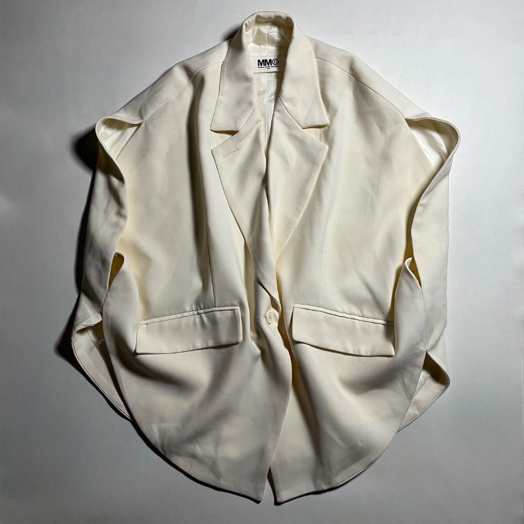 MM6 Maison Martin Margiela Circular Blazer Jacket (Category: Sleeveless) located in Caloocan City. Submitted by achilles_grails (Listing ID 1470728292, Image 1). Description: - Brand: MM6 Maison Martin Margiela - Style: Sleeveless blazer / vest in cream white - Design: Tailored lapels, front button closure, and waist flap pockets - Signature Detail: Iconic horizontal white stitching on the upper back - Fit: Structured silhouette with wide arm ope