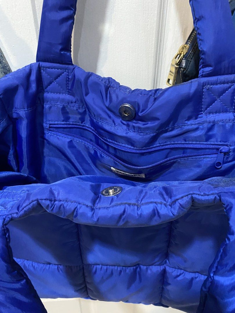 Monkl Puffer Tote Bag Blue Quilted (Category: Tote Bags) located in Manila. Submitted by rei.willdeclutter (Listing ID 1470698668, Image 3). Description: - Brand: Monki - Style: Quilted tote bag - Color: Royal blue - Material: Puffy nylon with grid stitching - Straps: Dual top shoulder straps - Closure: Magnetic snap button - Storage: Includes one interior zipper pocket - Condition: Clean inside and out, ready to use.