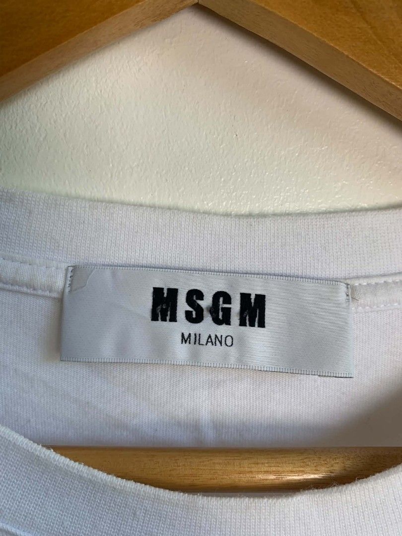 MSGM Milano White T-shirt with Black Logo Box (Category: Shirts) located in Manila. Submitted by michaelge38472 (Listing ID 1470705192, Image 3). Description: - Brand: MSGM Milano - Color: White - Style: Short sleeve tee with classic crew neck - Design: Large black box graphic with bold white lettering on the chest - Condition: Clean, minimal signs of wear - Vibe: Classic streetwear staple.