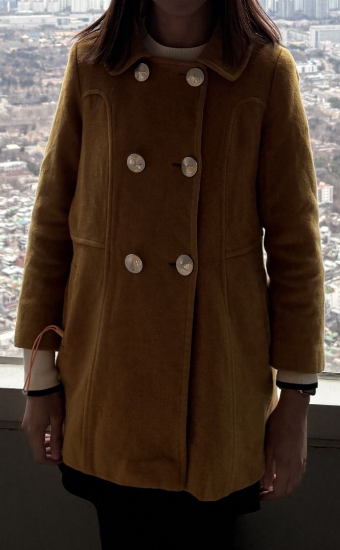 Mustard Yellow Double Breasted Wool Coat with Silver Buttons (Category: Coats, Jackets and Outerwear) located in Manila. Submitted by jira____ (Listing ID 1470683914, Image 1). Description: Mustard yellow wool coat, double breasted style. Features shiny silver tone buttons down the front and on the collar. Structured seaming detail along the front panels and waistline. Long sleeves with finished cuffs. Hits around mid thigh length. Warm winter pi