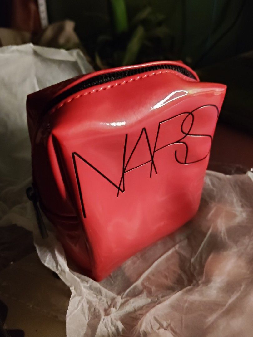 NARS Red Patent Makeup Bag Cosmetic Pouch (Category: Purses & Pouches) located in Quirino. Submitted by megay12 (Listing ID 1470696772, Image 1). Description: - Brand: NARS - Color: Bright red with shiny patent finish - Details: Embossed black logo lettering on the front, secure zip-top closure - Size: Compact boxy shape, ideal for travel or daily essentials - Condition: Pristine, clean inside and out.