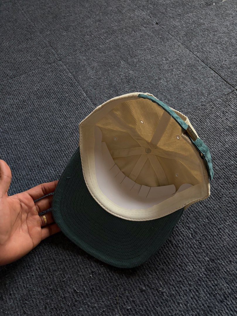 NEAT Corduroy Snapback Hat with Cricket Bug Embroidery (Category: Caps & Hats) located in Manila. Submitted by toys_hats005 (Listing ID 1470628756, Image 3). Description: - Brand: NEAT - Style: Corduroy cap with structured crown - Color: Cream body with dark green brim and strap - Design: Detailed cricket bug embroidery on front - Closure: Adjustable metal clasp (branded) - Condition: Pristine, clean fabric with no stains or wear marks.