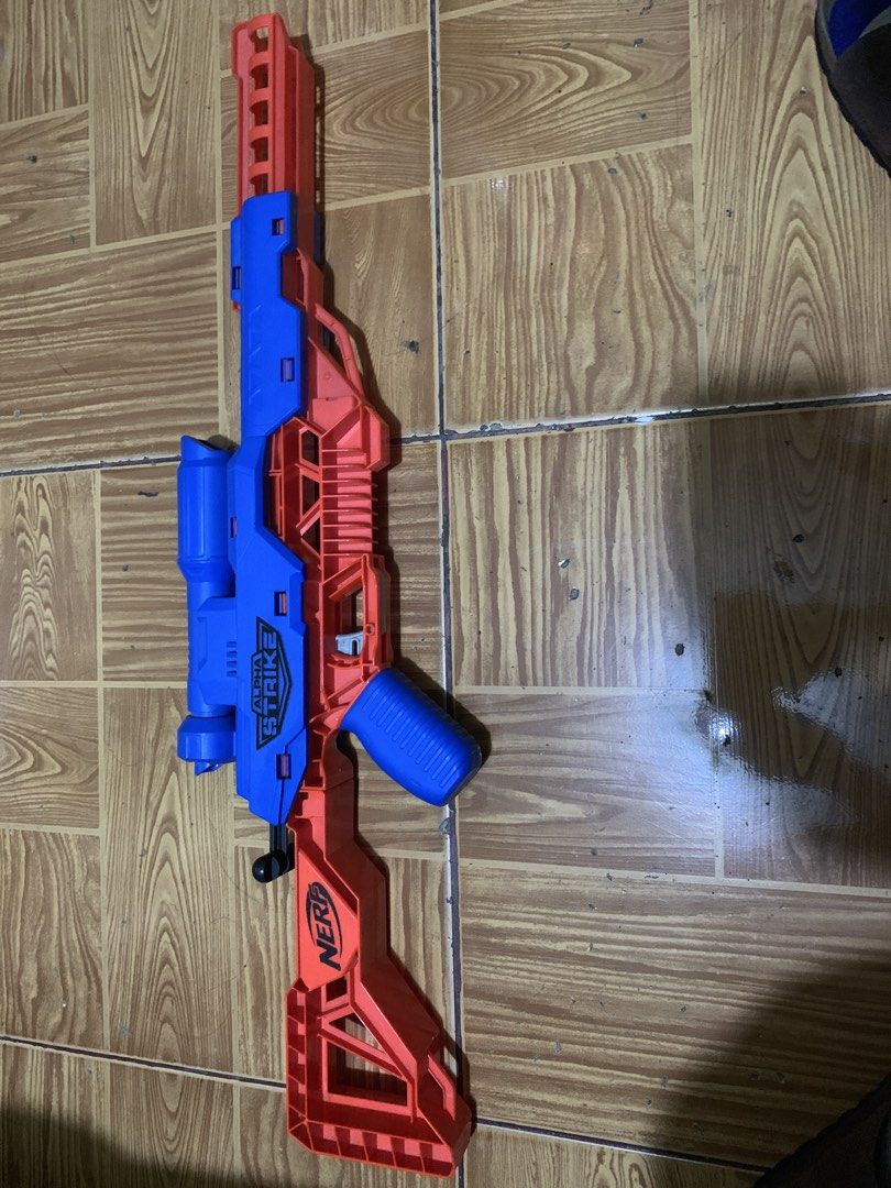 Nerf Alpha Strike Flyt Storm Blaster (Category: Action & Battle Toys) located in Antipolo. Submitted by cebb888 (Listing ID 1470638730, Image 3). Description: - Model: Nerf Alpha Strike Flyt Storm sniper rifle blaster - Color: Blue and orange - Size: Measures approximately 27 inches long - Features: Built-in scope and stock for better aim - Brand: Hasbro - Condition: Works great, ideal for indoor battles or backyard target practice - Where is as 
