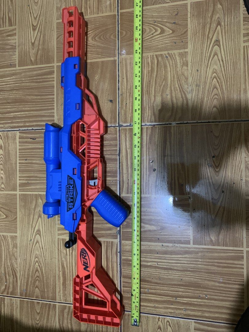 Nerf Alpha Strike Flyt Storm Blaster (Category: Action & Battle Toys) located in Antipolo. Submitted by cebb888 (Listing ID 1470638730, Image 1). Description: - Model: Nerf Alpha Strike Flyt Storm sniper rifle blaster - Color: Blue and orange - Size: Measures approximately 27 inches long - Features: Built-in scope and stock for better aim - Brand: Hasbro - Condition: Works great, ideal for indoor battles or backyard target practice - Where is as 