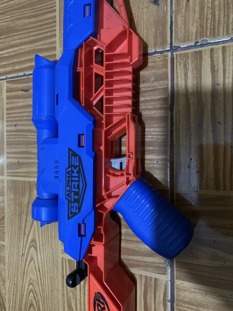 Nerf Alpha Strike Flyt Storm Blaster (Category: Action & Battle Toys) located in Antipolo. Submitted by cebb888 (Listing ID 1470638730, Image 2). Description: - Model: Nerf Alpha Strike Flyt Storm sniper rifle blaster - Color: Blue and orange - Size: Measures approximately 27 inches long - Features: Built-in scope and stock for better aim - Brand: Hasbro - Condition: Works great, ideal for indoor battles or backyard target practice - Where is as 