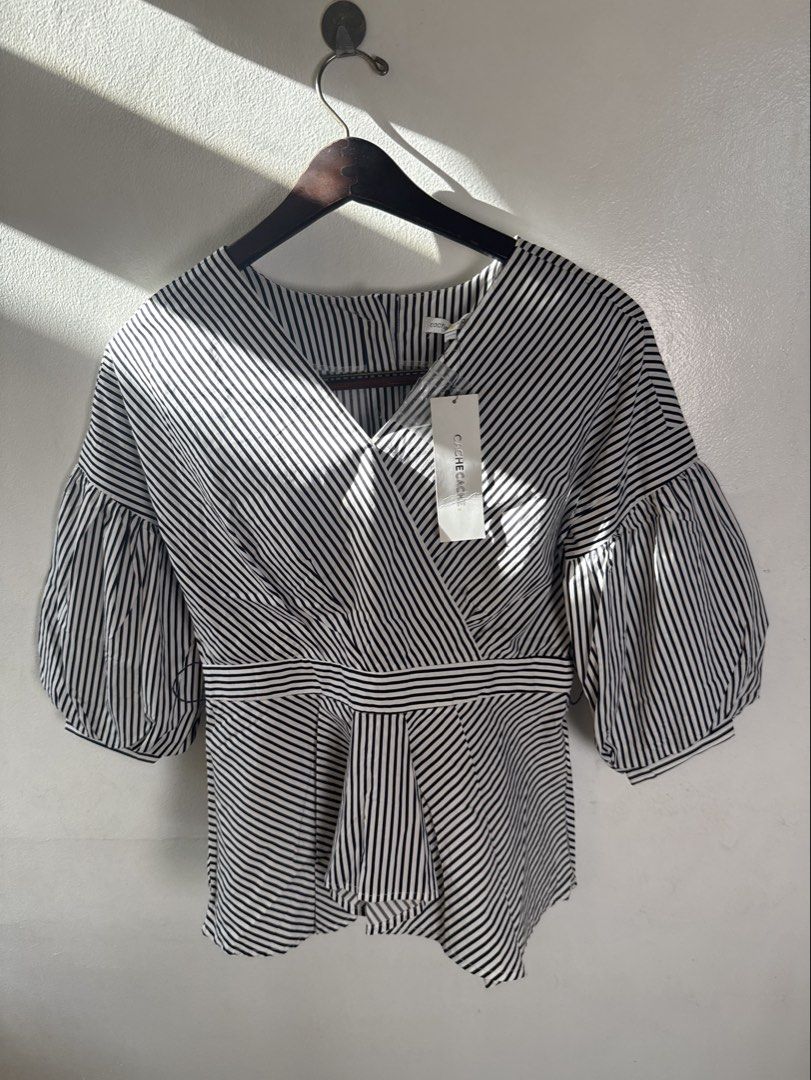 New w tags Cache Cache Black and White Striped Blouse (Category: Blouses) located in Quezon City. Submitted by dropdeadprices (Listing ID 1470620544, Image 1). Description: - Brand: Cache Cache (With tag attached, never worn) - Material: 100% breathable cotton - Design: Classic black and white stripes with a V-neck wrap front Issue: missing belt - Sleeves: Stylish voluminous balloon sleeves - Fit: Flattering fitted waist with a flared peplum hem 