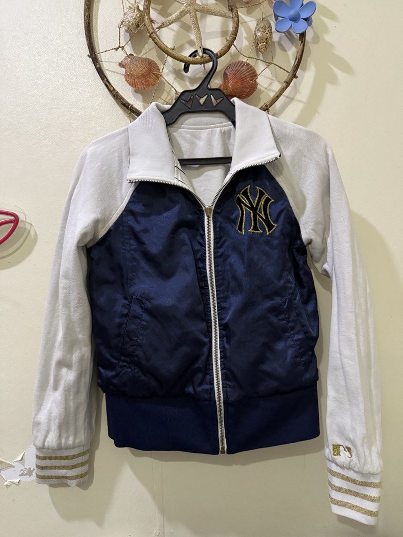 New York Yankees Reversible Bomber Jacket MLB (Category: Coats, Jackets and Outerwear) located in Cebu City. Submitted by hotchkisscebu (Listing ID 1470682501, Image 2). Description: - Official MLB New York Yankees reversible jacket - Side 1: Classic white pinstripes with large script Yankees chest lettering - Side 2: Solid navy blue with embroidered NY chest logo - Full zip front with comfortable ribbed collar and gold-accented striped cuffs - F