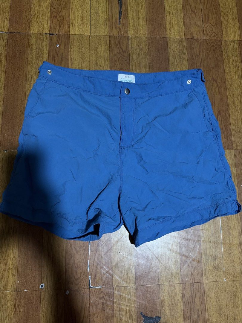 Next Swimwear Blue Board Shorts (Category: Swim Trunks & Board Shorts) located in Manila. Submitted by annabananna (Listing ID 1470682288, Image 1). Description: - Brand/Model: Next Swimwear - Color: Bright blue - Waistband: Fitted with metal button closure and side snaps - Pockets: Deep front hip pockets - Fabric: Lightweight and ultra fast-drying - Condition: Clean inside and out, ready to wear.
