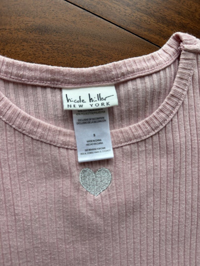Nicole Miller Top and Pants Set (Category: Babies & Kids Fashion) located in Makati City. Submitted by juju_08 (Listing ID 1470567936, Image 2). Description: - Brand: Nicole Miller New York - Size: Small (tag attached) - Color: Pink - Material: Cotton and polyester blend - Design: Ribbed short-sleeve top with small silver embroidered heart and tiny side bows on the hem - Bottoms: Matching flared pants - Condition: Brand new with tags.