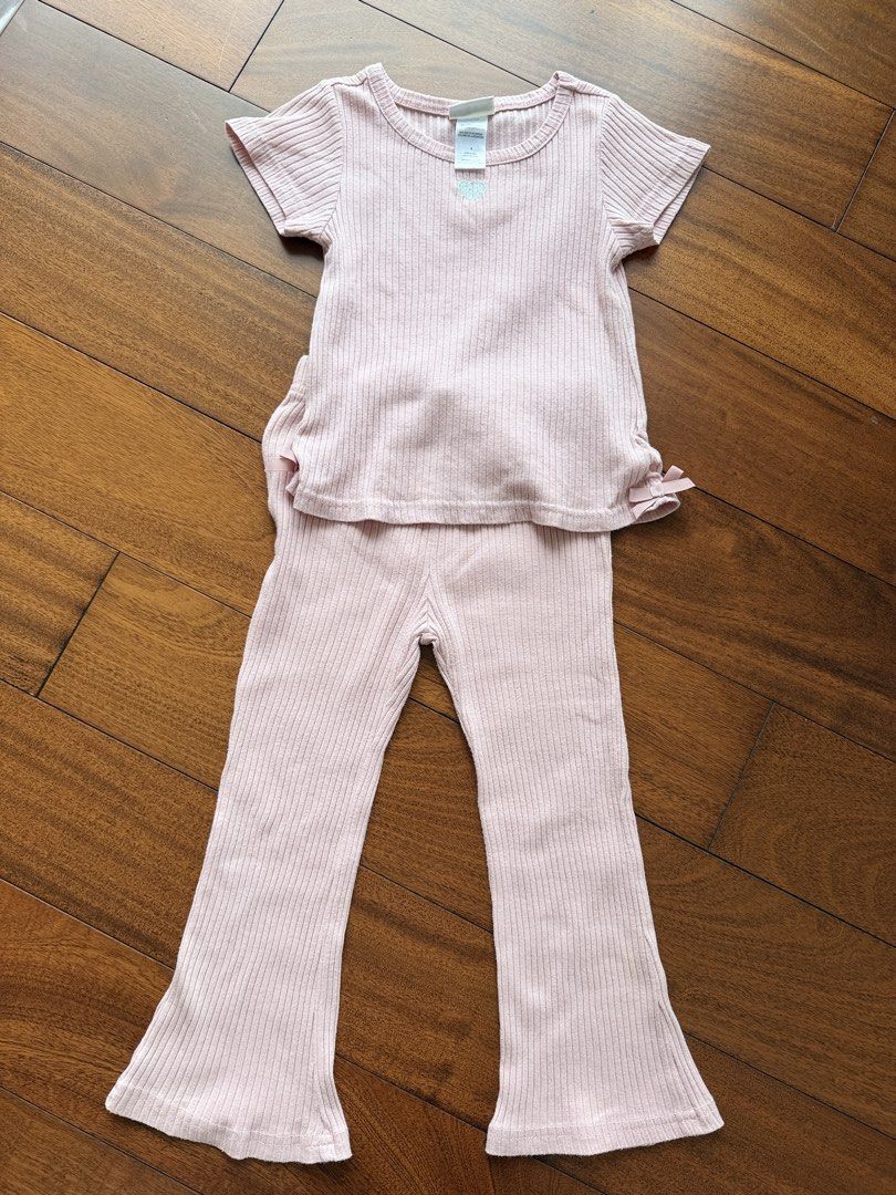 Nicole Miller Top and Pants Set (Category: Babies & Kids Fashion) located in Makati City. Submitted by juju_08 (Listing ID 1470567936, Image 1). Description: - Brand: Nicole Miller New York - Size: Small (tag attached) - Color: Pink - Material: Cotton and polyester blend - Design: Ribbed short-sleeve top with small silver embroidered heart and tiny side bows on the hem - Bottoms: Matching flared pants - Condition: Brand new with tags.