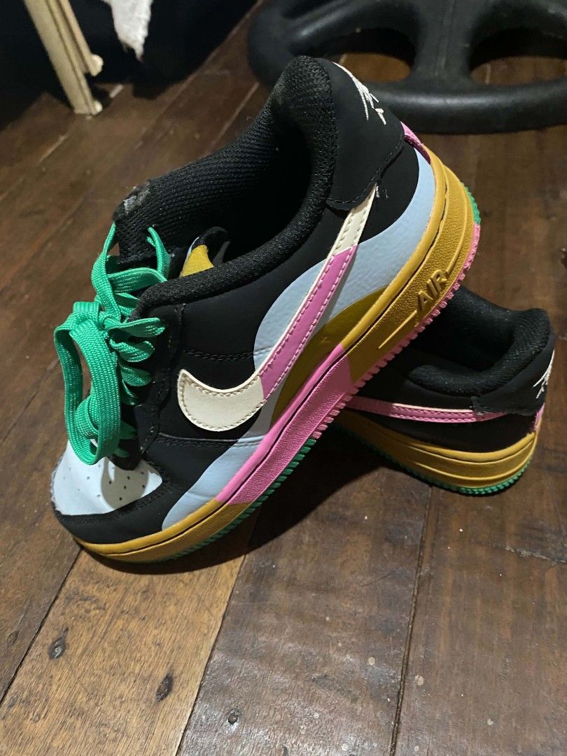 Nike Air Force 1 Low Multicolour (Category: Babies & Kids Fashion) located in Navotas City. Submitted by piozonvhon (Listing ID 1470567246, Image 2). Description: Multicolour Nike Air Force 1 Low sneakers. Bold mix of black, yellow, pink, light blue, and green panels. Bright green laces. Yellow tongue tag with Nike branding. Upside down Nike Air logo embroidered on the heel tabs. Visible wear on the collar lining with a small rip. Pink and green 