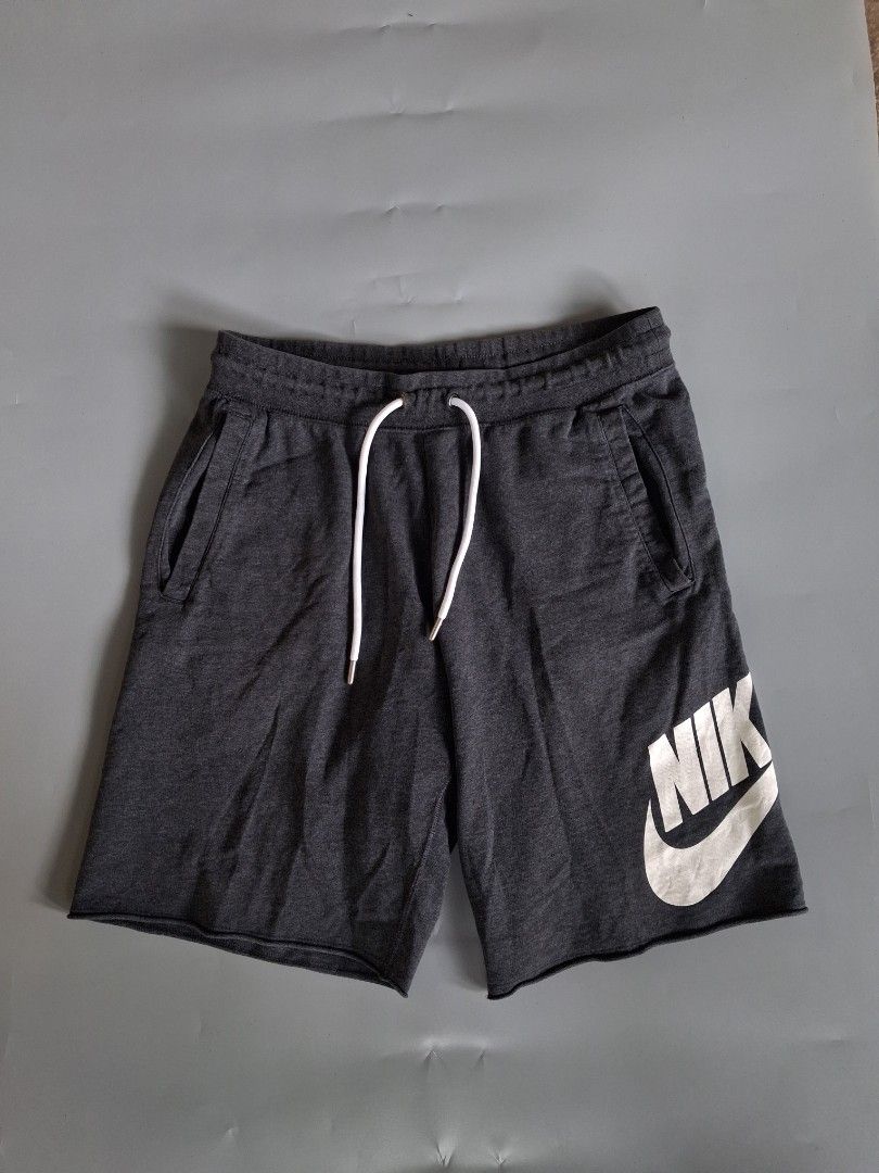 Nike Alumni charcoal grey sweatshorts with drawstring (Category: Shorts) located in Pamplona. Submitted by edrick_thrift (Listing ID 1470682957, Image 1). Description: N*ke Alumni Dark Grey shorts⚫️ ▫️as new ▫️excellent condition ▫️waist 30-34(stretchable) ▫️length 19 ▫️issue: minimal crackprint(last pic).