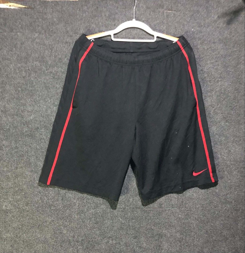 Nike Black Athletic Shorts with Red Piping (Category: Shorts) located in Manila. Submitted by thriftnipaps (Listing ID 1470676318, Image 1). Description: - Brand: Nike - Color: Black with bright red piping - Logo: Small red embroidered Swoosh near the left hem - Waistband: Elastic with a functional drawstring channel - Material: Lightweight and breathable - Ideal For: Running, gym workouts, or casual sporty looks - Condition: Excellent.