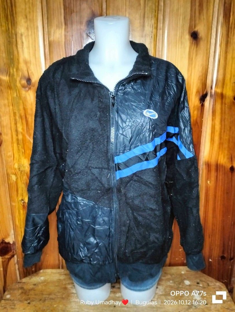 Nike Black Blue Reversible Fleece Jacket XL (Category: Coats, Jackets and Outerwear) located in Baguio. Submitted by jnjayceelbrn (Listing ID 1470613912, Image 1). Description: - Brand: Nike - Style Code: FB1821-010 - Size: XL - Color: Black and blue - Material: Fleece texture mixed with nylon panels - Design: Blue stripe accents with large blue Nike lettering on the back - Features: Front pockets, full zip closure - Condition/Origin: Made in Chi