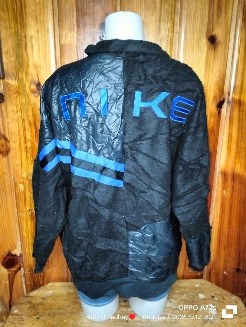 Nike Black Blue Reversible Fleece Jacket XL (Category: Coats, Jackets and Outerwear) located in Baguio. Submitted by jnjayceelbrn (Listing ID 1470613912, Image 2). Description: - Brand: Nike - Style Code: FB1821-010 - Size: XL - Color: Black and blue - Material: Fleece texture mixed with nylon panels - Design: Blue stripe accents with large blue Nike lettering on the back - Features: Front pockets, full zip closure - Condition/Origin: Made in Chi