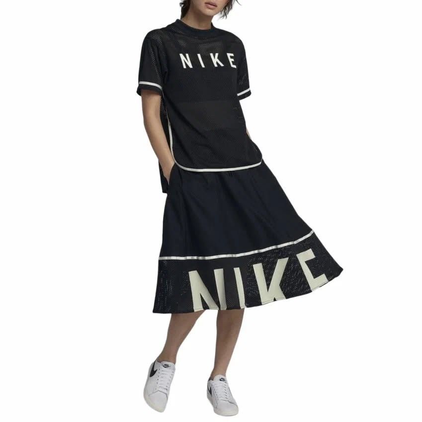 Nike Black Mesh Hem Skirt (Category: Skirts) located in Manila. Submitted by jc.dingz1024 (Listing ID 1470720457, Image 3). Description: - Brand: Nike - Style: Sporty midi skirt with drawstring waist and side pockets - Design: Solid fabric on top, mesh hem at the bottom - Details: Reflective stripe divider and bold white Nike lettering on front and back - Versatility: Great for gym workouts or casual everyday styling - Condition: Excellent (ready
