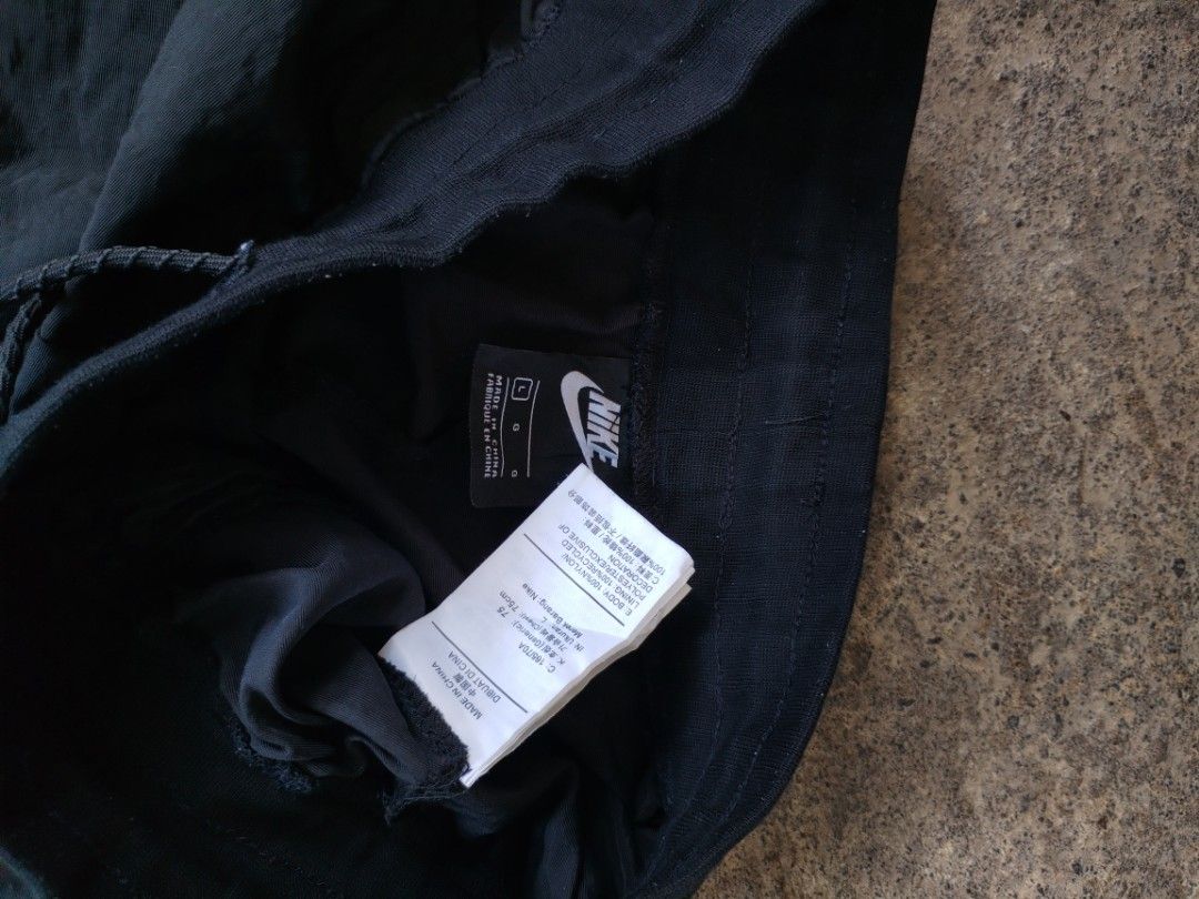 Nike Black Nylon Shorts with Snap Buttons Size L (Category: Shorts) located in Legazpi City. Submitted by justinbarcelon (Listing ID 1470683774, Image 2). Description: - Brand: Nike - Color: Black with white embroidered logo - Size: L - Material: 100% nylon body, 100% recycled polyester lining - Features: Elastic waistband with adjustable drawstring, full snap-button sides - Origin: Made in China - Condition: Excellent/Brand New.