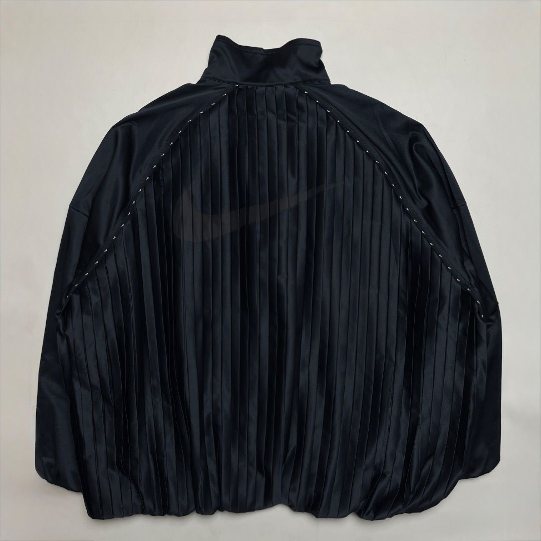 Nike Black Pleated Track Jacket (Category: Coats, Jackets and Outerwear) located in Caloocan City. Submitted by achilles_grails (Listing ID 1470727106, Image 2). Description: - Brand: Nike - Item: Full-Zip Track Jacket - Color: Black - Size: L (Tag intact) - Design: Unique pleated front and back panels - Material: Body: 96% polyester, 4% spandex | Lining: 79% polyester, 21% spandex - Features: Breathable mesh interior lining, mock neck collar, ri