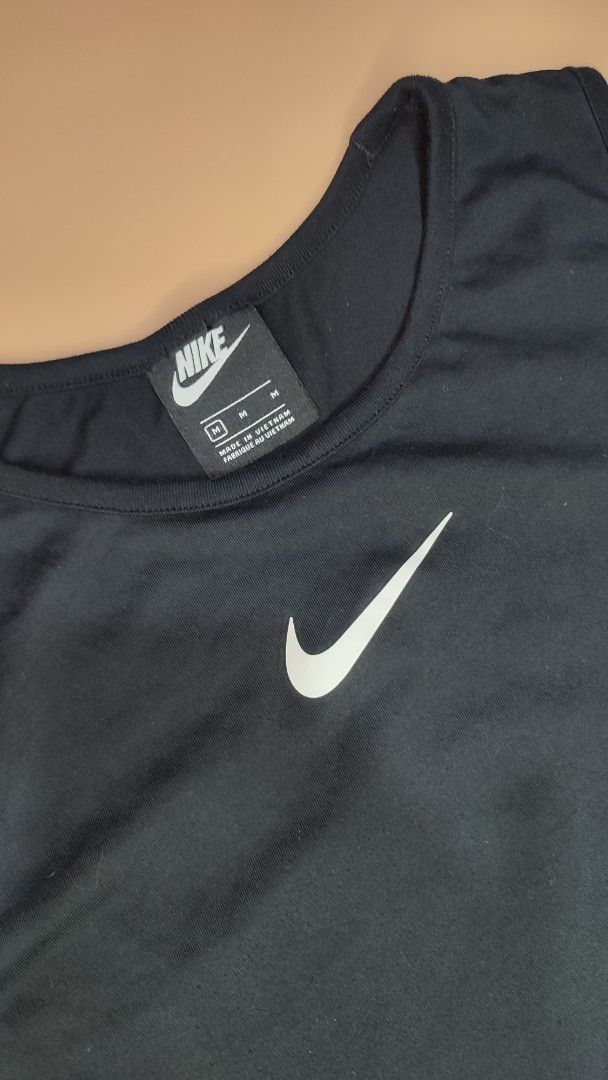 Nike Black Tank Top With Large Swoosh Size M (Category: Sleeveless) located in Cavite. Submitted by juanpraktikal (Listing ID 1470738921, Image 3). Description: -Maganda din fit sa mens 😊 - Brand: Nike - Style: Tank top with giant back swoosh and small chest swoosh - Color: Black - Size: Medium (20.5" width x 27" length) - Material: 76% polyester, 24% cotton - Origin: Made in Vietnam - Style Code: CW3217-010 - Condition: Clean, excellent, and re
