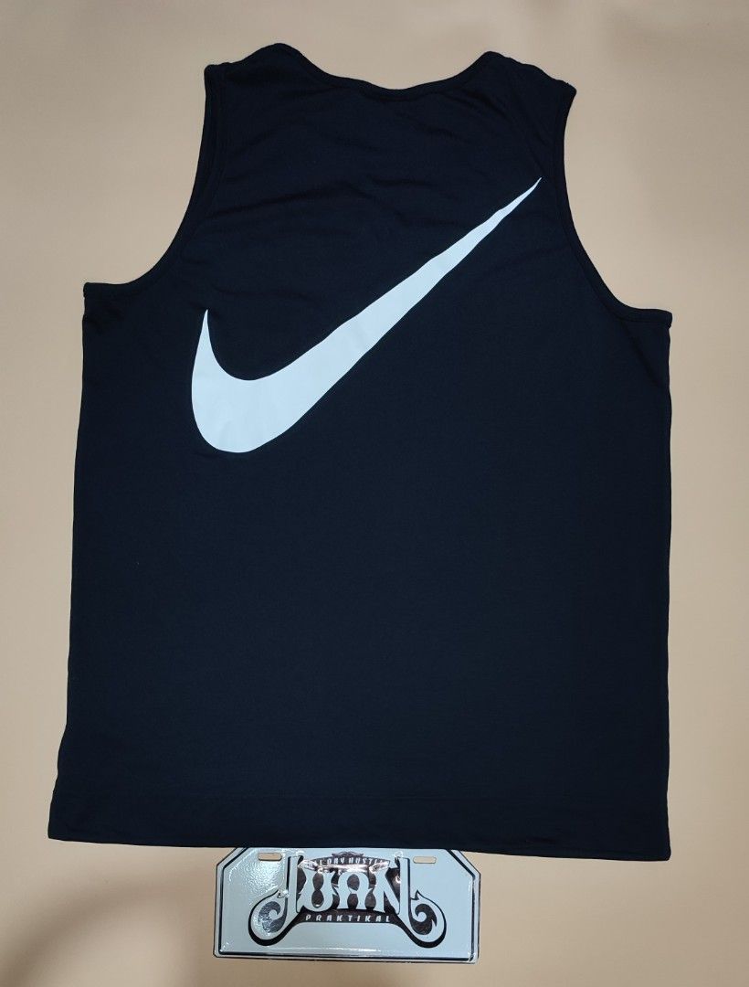 Nike Black Tank Top With Large Swoosh Size M (Category: Sleeveless) located in Cavite. Submitted by juanpraktikal (Listing ID 1470738921, Image 2). Description: -Maganda din fit sa mens 😊 - Brand: Nike - Style: Tank top with giant back swoosh and small chest swoosh - Color: Black - Size: Medium (20.5" width x 27" length) - Material: 76% polyester, 24% cotton - Origin: Made in Vietnam - Style Code: CW3217-010 - Condition: Clean, excellent, and re