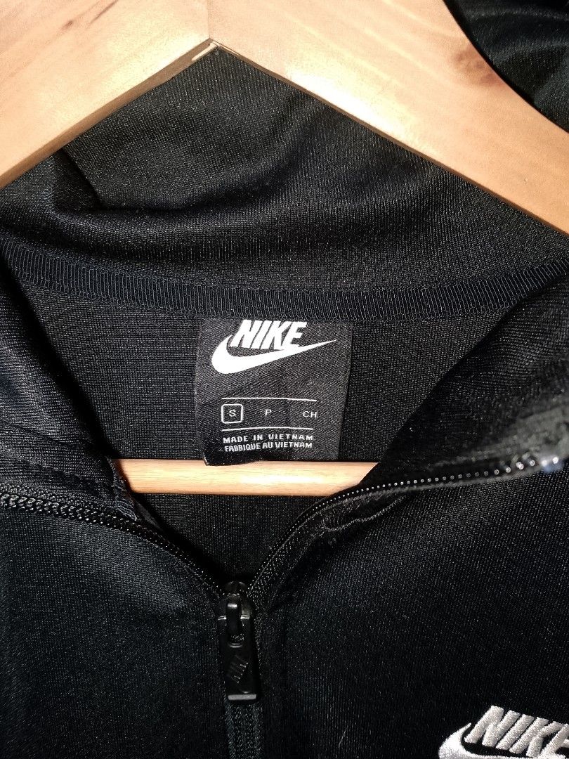 Nike Black Track Jacket Size S (Category: Coats, Jackets and Outerwear) located in Manila. Submitted by mjthrifted_second (Listing ID 1470608102, Image 3). Description: - Brand: Nike - Item: Black track jacket with white side stripes - Size: S (Made in Vietnam) -Dimes: 21/26 - Material: 100% polyester body, cotton pocket bags - Features: Full zip closure, embroidered chest logo, zippered side pockets - Condition: Clean inside and out, excellent p