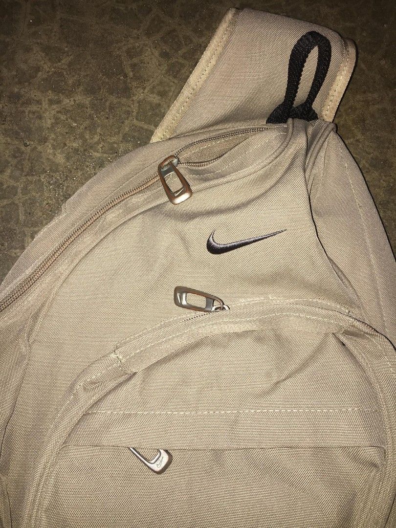 Nike Brown Multi-Pocket Sling Bag (OS) (Category: Sling Bags) located in Quezon City. Submitted by thriftyzx (Listing ID 1470709618, Image 3). Description: Nike Brown Multi-Pocket Sling Bag (OS) Condition: 9/10 Issue: yung isa nawala yung zipper then may hole sa likod no visible working all zipper 1500+SF Location: QC.