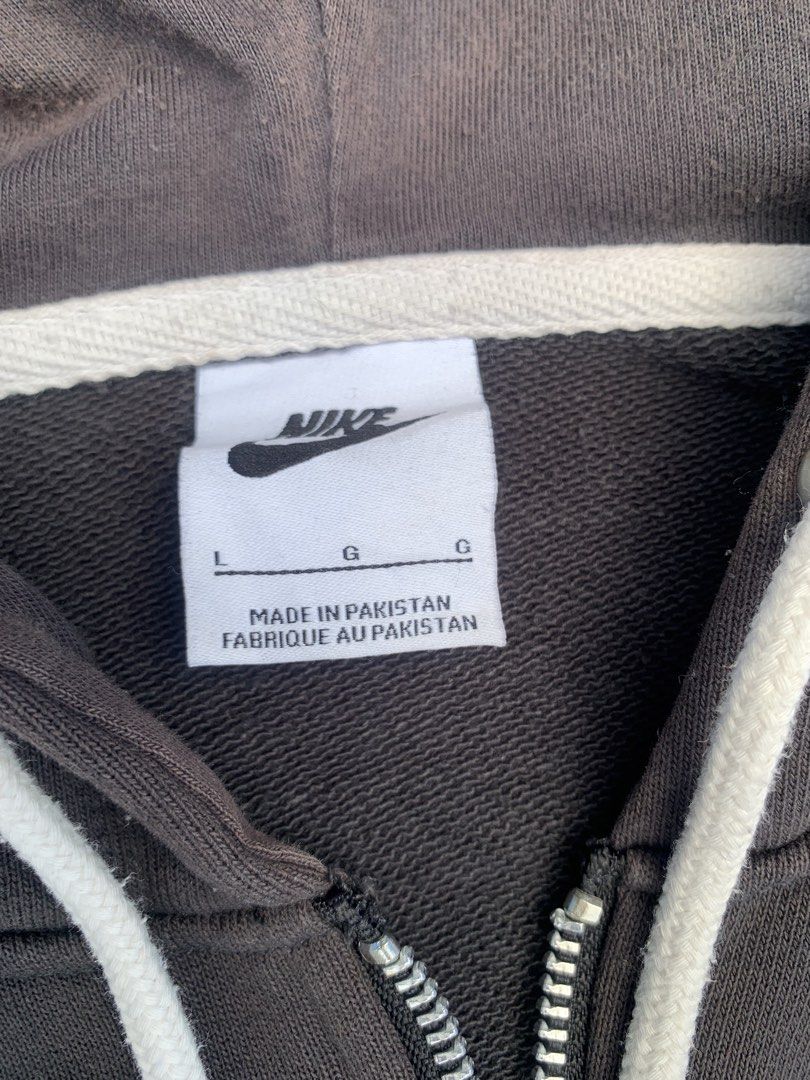 Nike Brown Quarter Zip Hoodie (Category: Coats, Jackets and Outerwear) located in Tarlac. Submitted by durkk4ever (Listing ID 1470722267, Image 3). Description: - Brand: Nike - Style: Quarter-zip hoodie with metal zipper closure and white adjustable drawstring hood - Color: Dark Brown - Size: L - Material: 98% cotton, 2% spandex (Made in Pakistan) - Details: Embroidered retro Nike swoosh logo on chest, front kangaroo pocket, and ribbed side panel