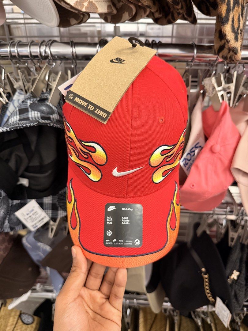 Nike Club Cap Red Flame Print Move To Zero (Category: Caps & Hats) located in Manila. Submitted by thriftsbyfelas (Listing ID 1470672559, Image 1). Description: - Brand: Nike Club Cap - Color: Bright red with trendy flame graphics on sides and brim - Logo: Embroidered white Swoosh on the front - Fit: Adjustable back strap, Size M/L adult fit - Condition: Brand new with attached Move to Zero cardboard tag and original black product sticker - Perfe