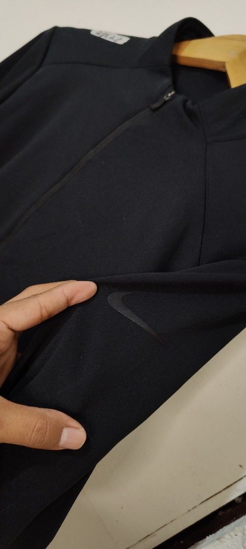 Nike Dri-Fit Black 1/4 Zip Pullover (Category: Coats, Jackets and Outerwear) located in Bulacan. Submitted by adrian2325 (Listing ID 1470641726, Image 3). Description: - Brand: Nike - Style: Dri-Fit quarter-zip mock neck pullover - Color: Solid Black - Size: Medium (tag at collar) - Material: 100% lightweight polyester - Origin: Made in Thailand - Condition: Clean overall shape, great for workouts or casual wear.