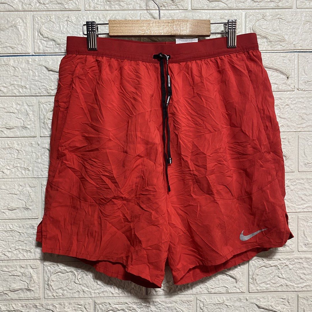 Nike Dri-FIT Red Running Shorts Size S (Category: Shorts) located in Naga. Submitted by thesource4400 (Listing ID 1470674673, Image 1). Description: - Brand: Nike - Item: Running Shorts - Color: Red - Size: Small (on tag) - Condition: Excellent - Material: Dri-FIT lightweight fabric with breathable mesh side panels - Features: Elastic waistband with inner drawstring, secure back zippered pocket, and reflective Nike swoosh logo - Origin: Made in C