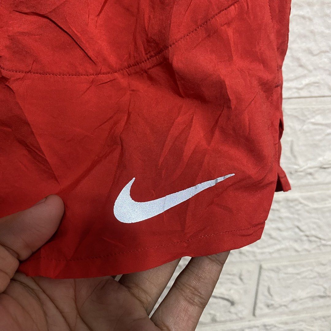 Nike Dri-FIT Red Running Shorts Size S (Category: Shorts) located in Naga. Submitted by thesource4400 (Listing ID 1470674673, Image 3). Description: - Brand: Nike - Item: Running Shorts - Color: Red - Size: Small (on tag) - Condition: Excellent - Material: Dri-FIT lightweight fabric with breathable mesh side panels - Features: Elastic waistband with inner drawstring, secure back zippered pocket, and reflective Nike swoosh logo - Origin: Made in C